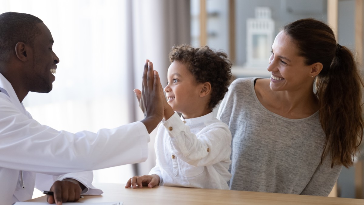 doctor high-fiving a young patient