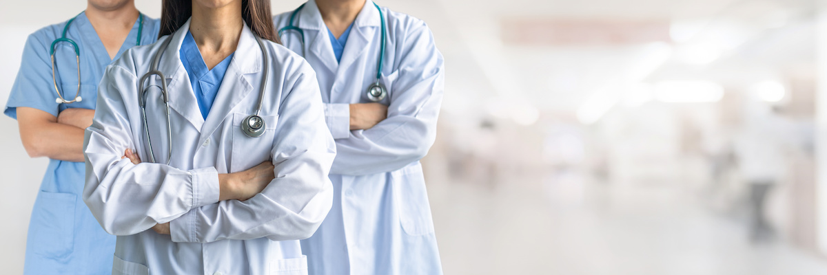 group of radiation oncologists standing with their arms crossed